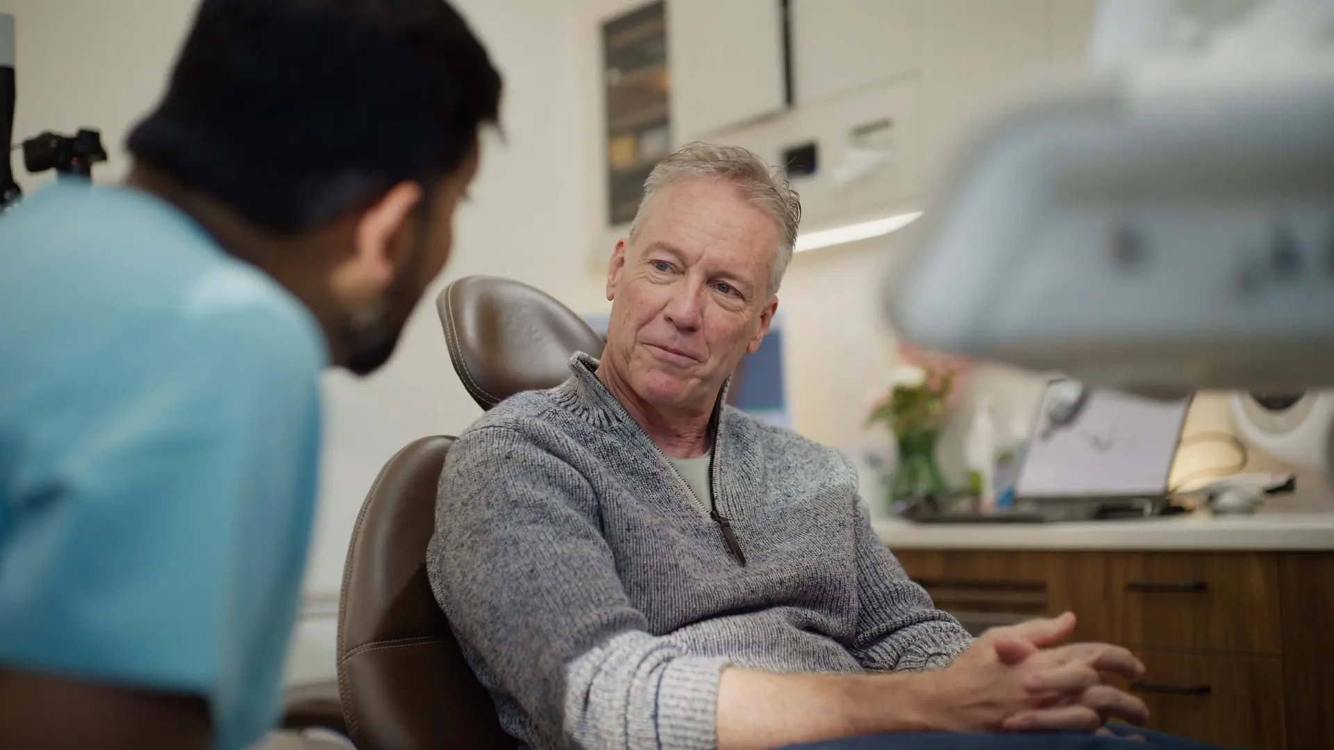 A patient talking with the dentist in the dental chair