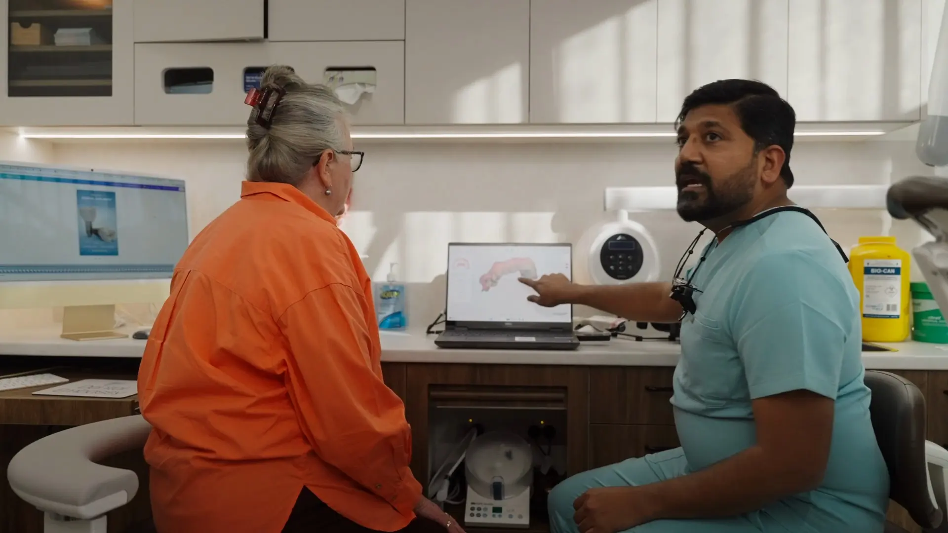 Dr Sri reviewing a scan on screen with a patient