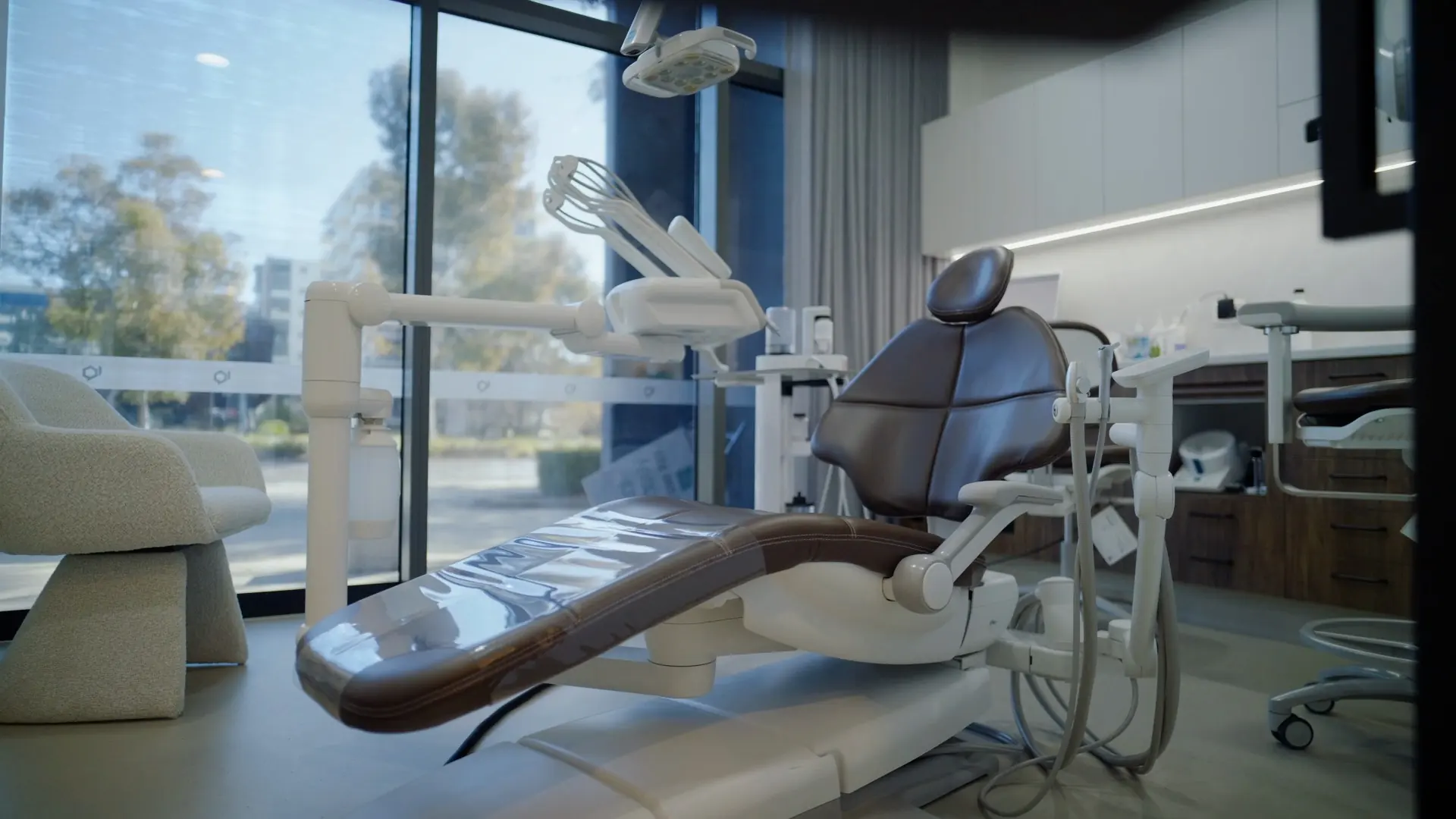 A dental chair beside the window in a Dental Embassy treatment room