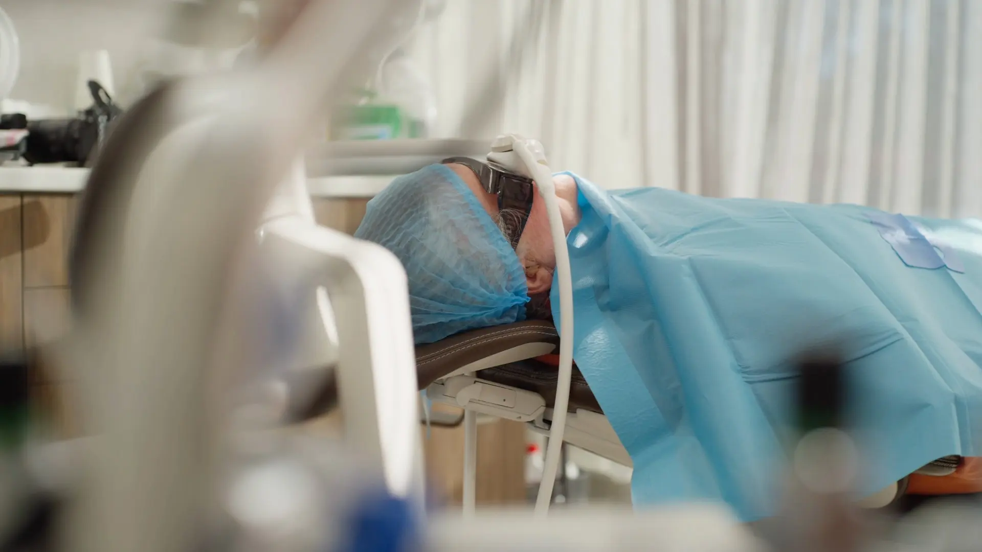 A patient draped and resting in the chair during an IV sedation appointment