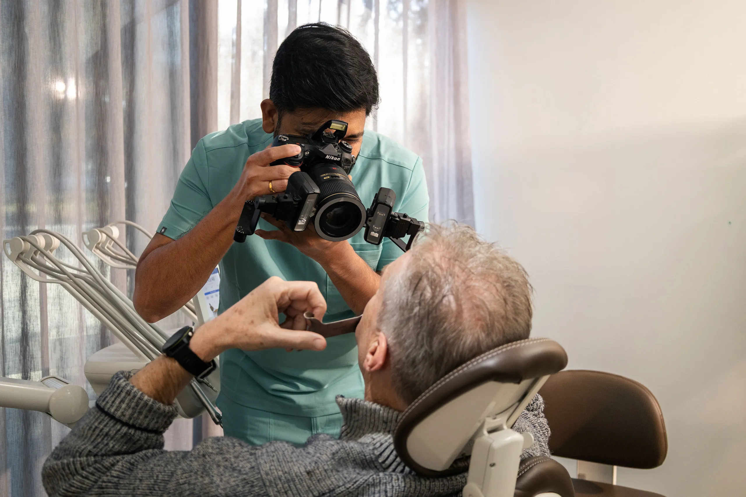 Dentist assessing a chipped front tooth at Dental Embassy in Braddon, Canberra