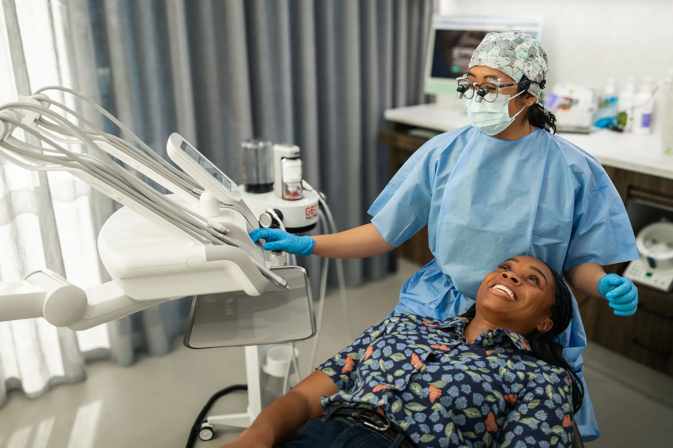 Dentist reviewing an x-ray with a patient to discuss saving or removing a tooth, Braddon Canberra