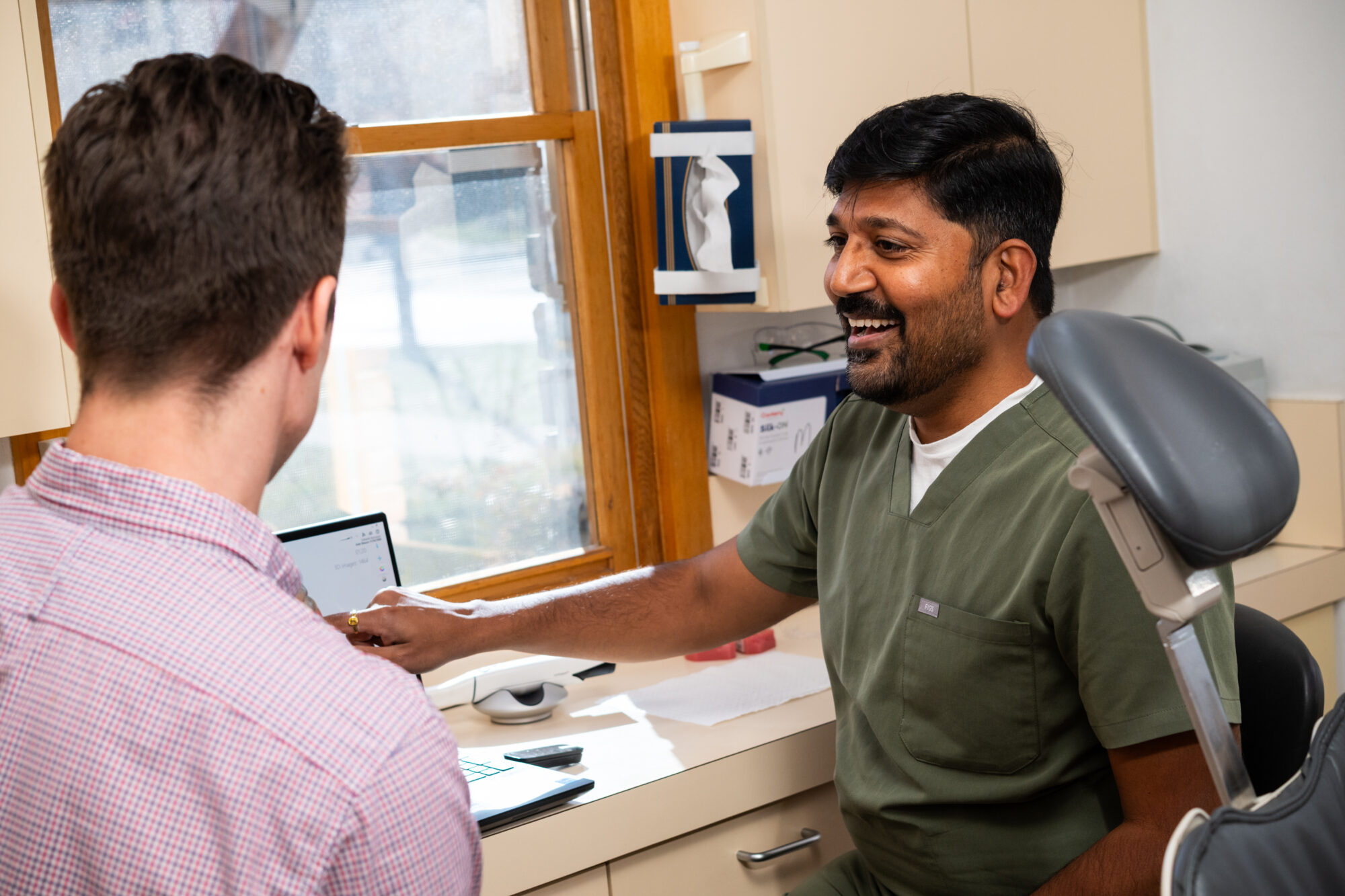 Dr Sri consulting with a patient at Dental Embassy Braddon