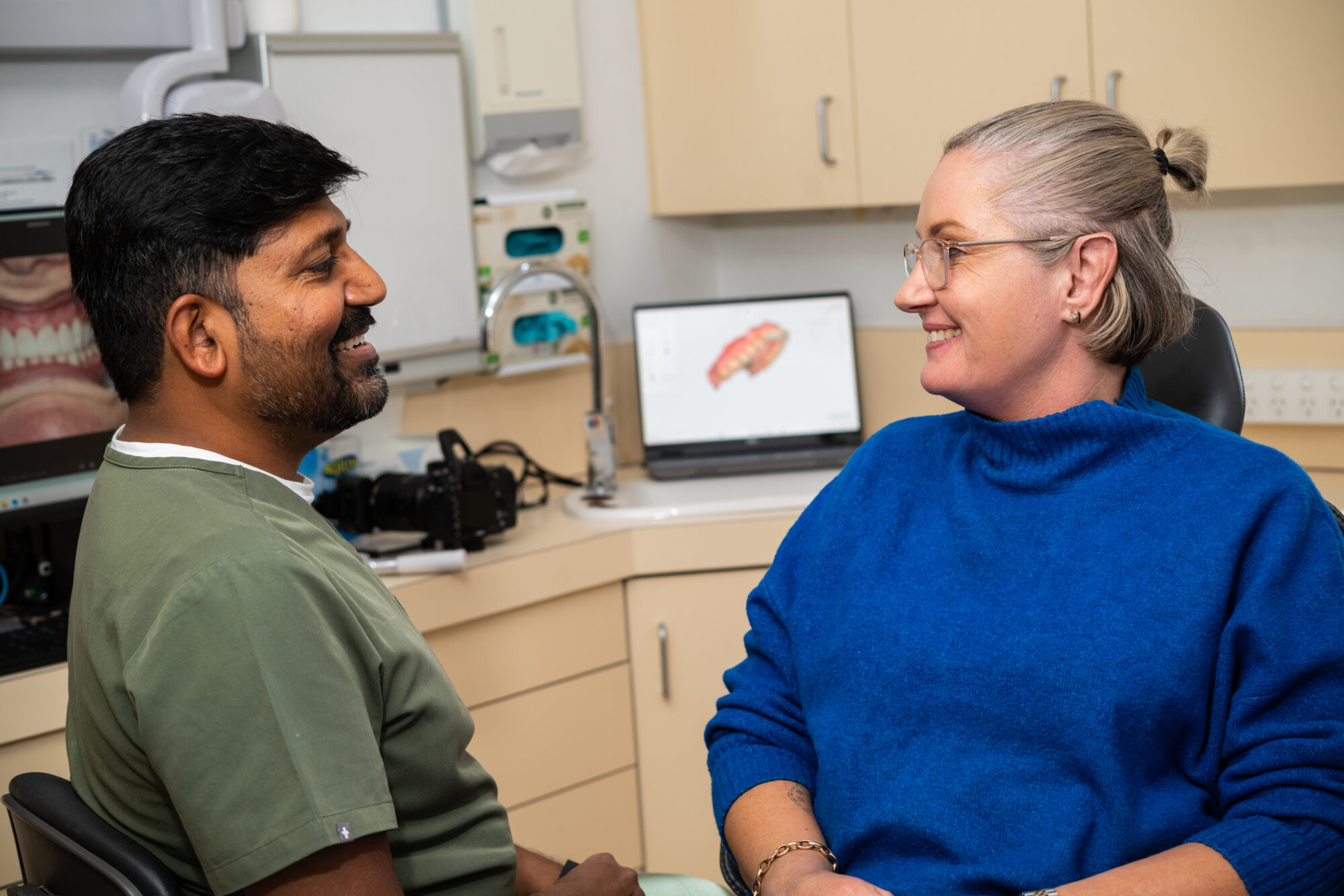 Dentist reviewing x-rays with a patient after a long gap, Braddon Canberra